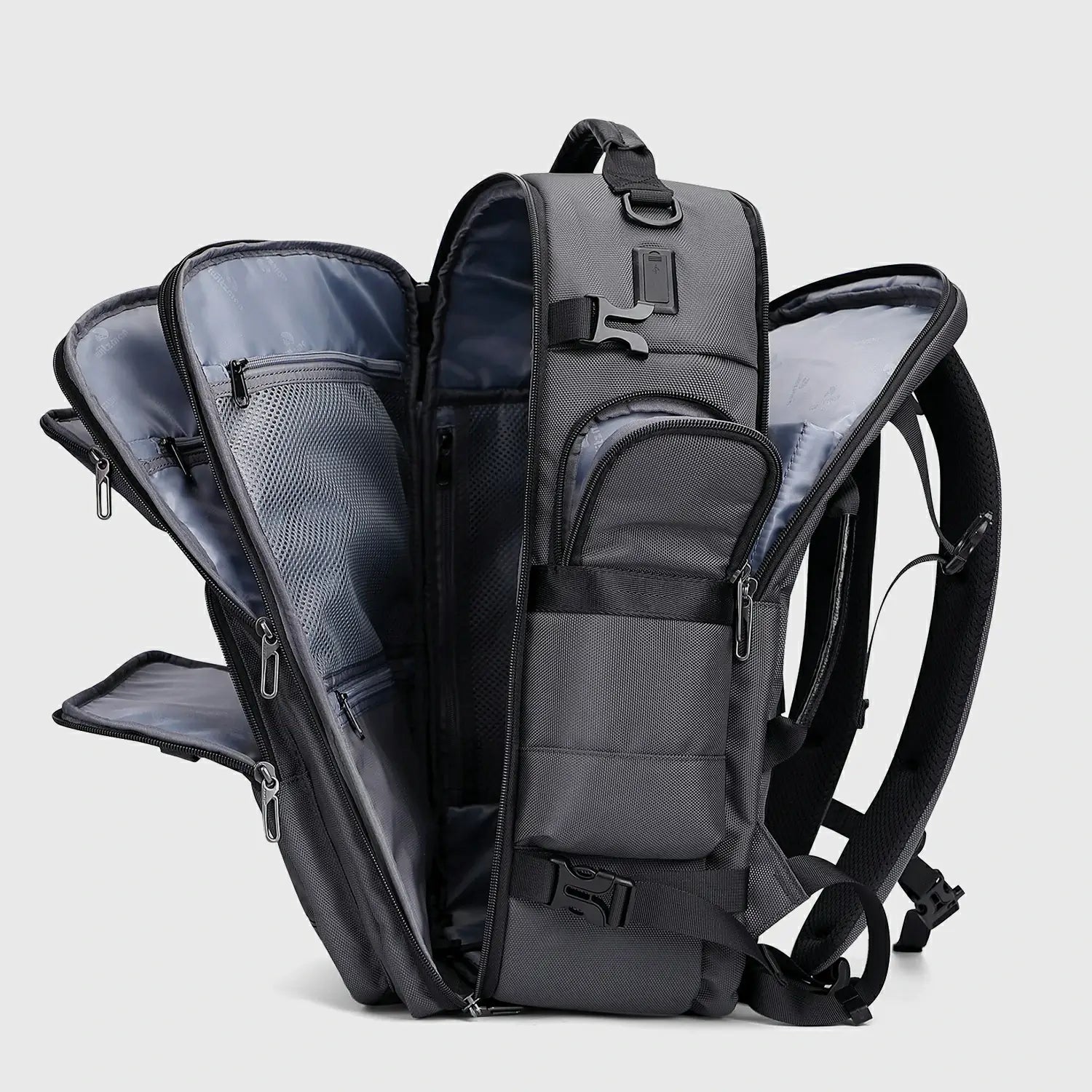 Silver grey multifunctional travel backpack showing layered compartments and multiple openings