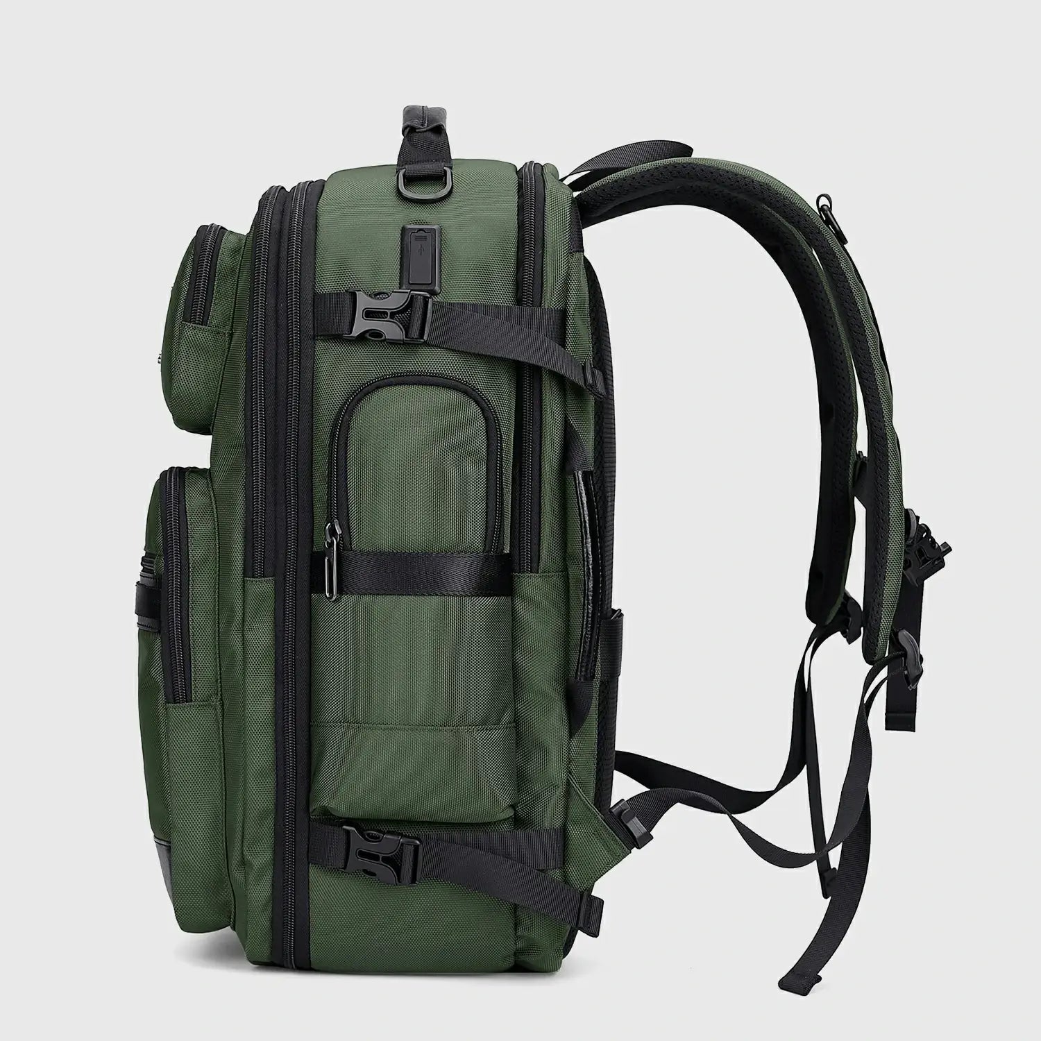 Side view of army green nylon travel backpack with USB charging ports and padded straps