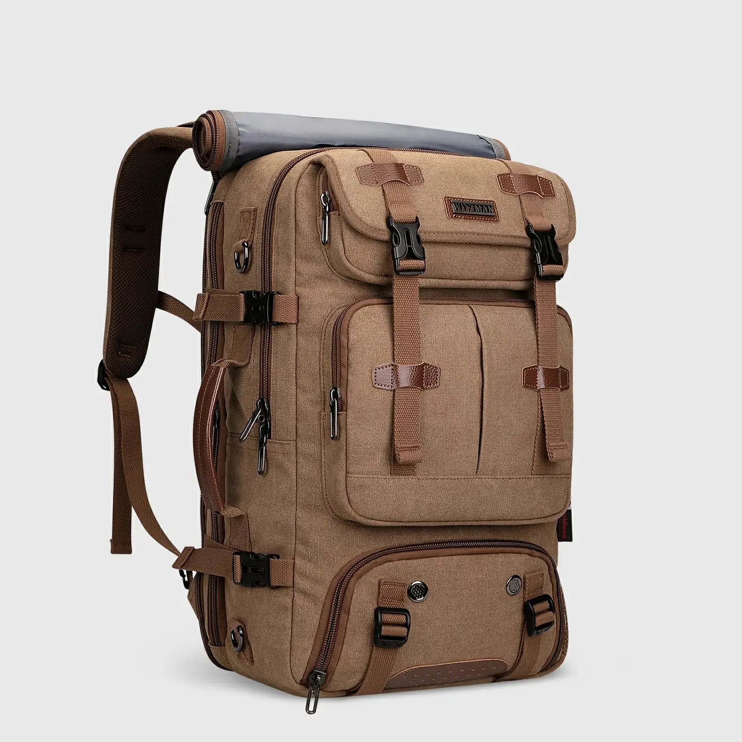 Brown canvas carry-on travel backpack for men shown from the front side angle