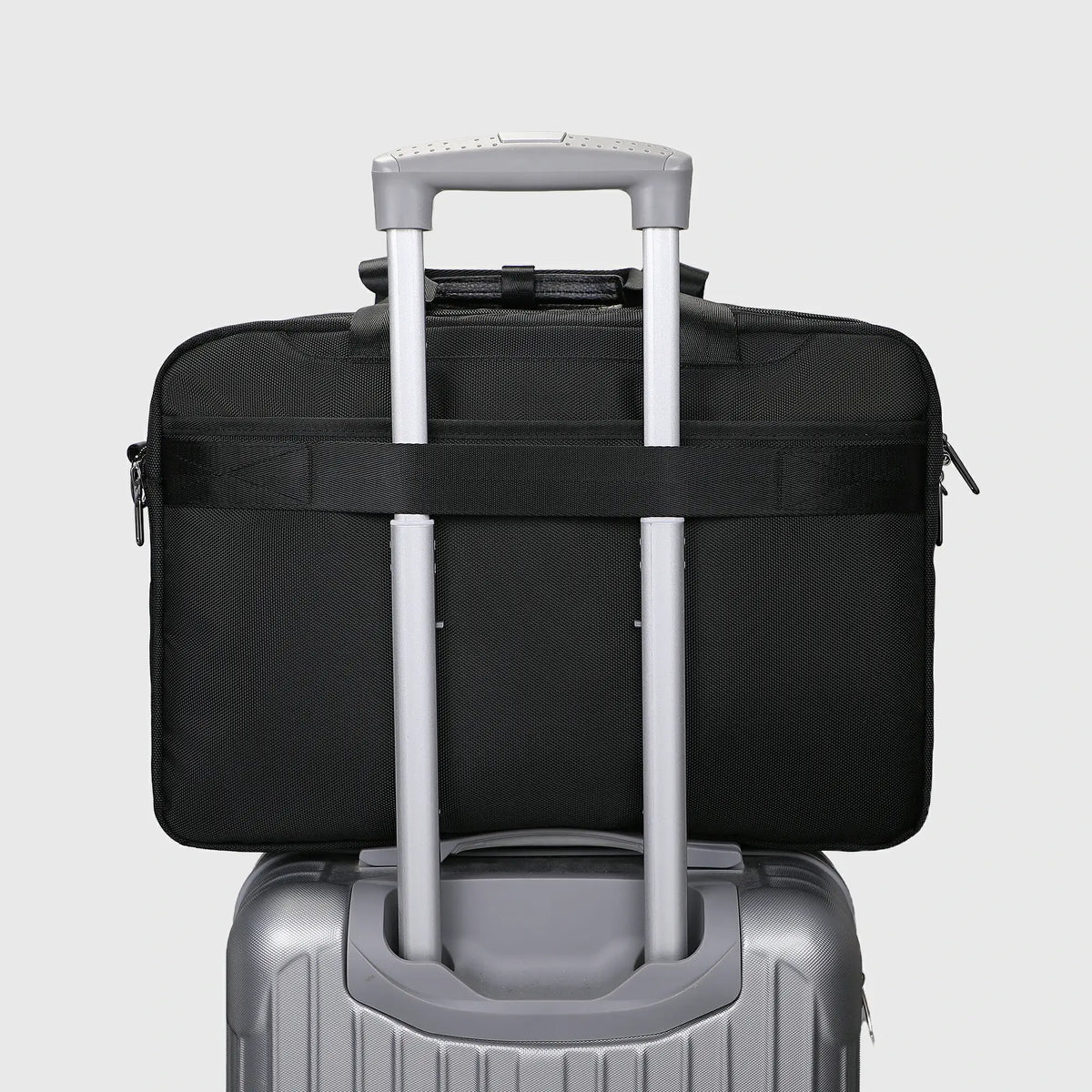 Nylon travel laptop briefcase with concealed rear zippered pocket and luggage trolley strap for business trips