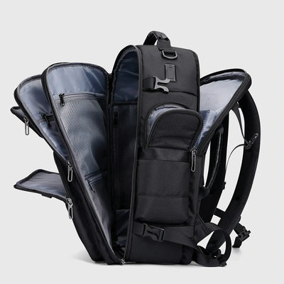 Black multifunctional travel backpack showing layered compartments and multiple access openings