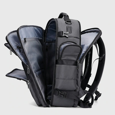 Silver grey multifunctional travel backpack showing layered compartments and multiple openings