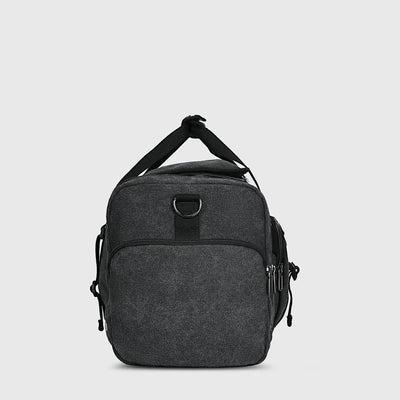 Black canvas travel duffel bag with shoe compartment wet dry pocket and luggage sleeve
