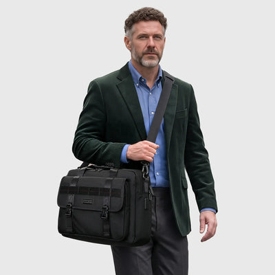 Black WITZMAN laptop shoulder bag with concealed rear zipper pocket and luggage trolley strap for business travel.