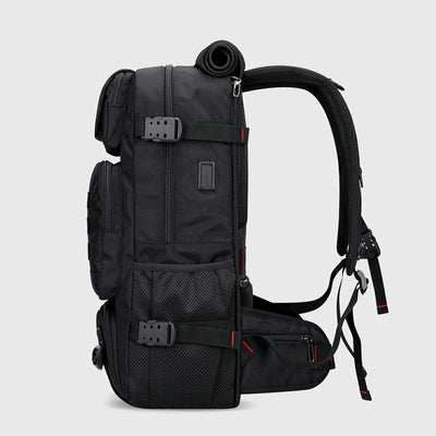 Side view of black nylon travel backpack with USB charging port and compression straps