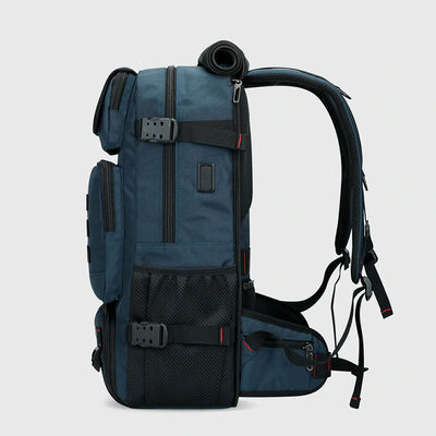 Side view of blue nylon travel backpack with USB charging port and compression straps