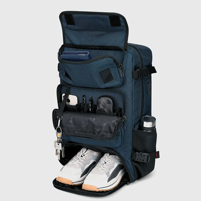 Blue travel backpack with separate shoe compartment and front organizer pockets open