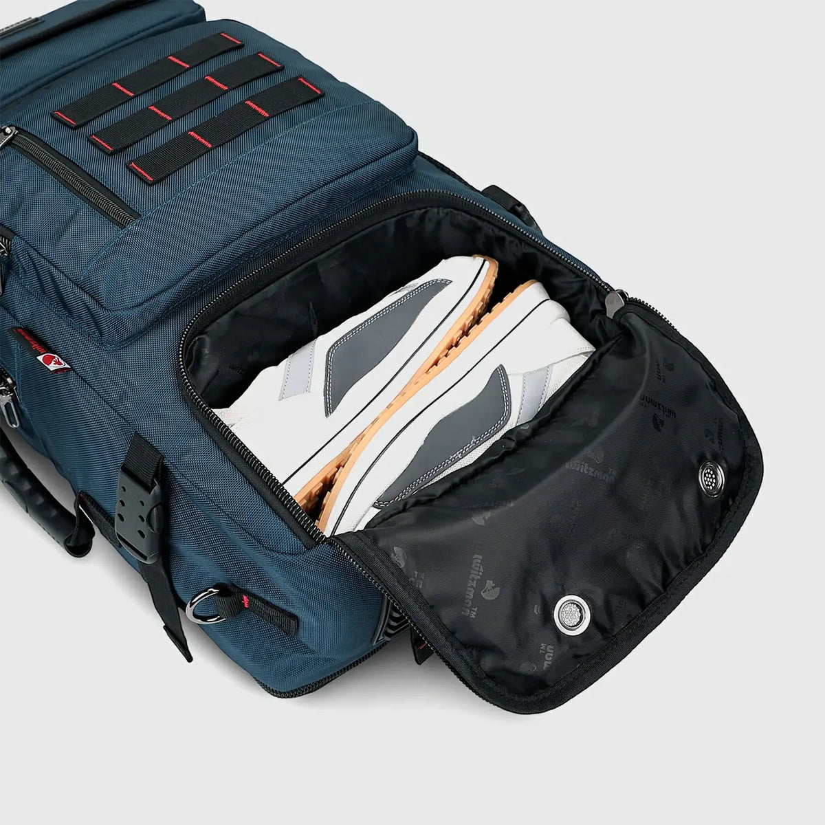 Close-up of separate shoe compartment in blue men’s weekend travel backpack