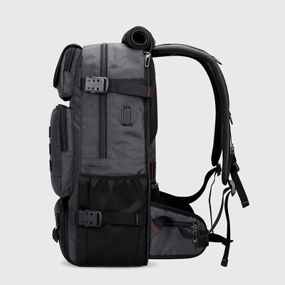 Side view of silvery grey nylon travel backpack with USB port and compression straps