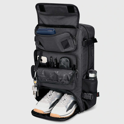 Silvery grey travel backpack with separate shoe compartment and front pockets open