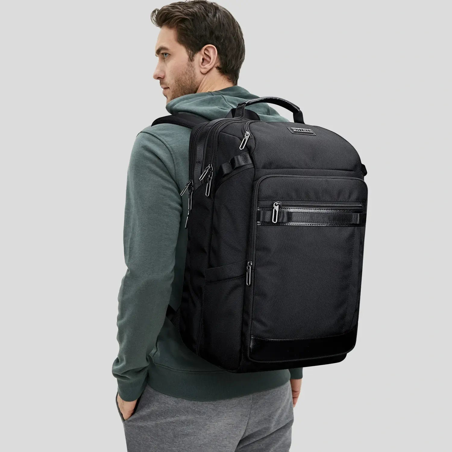 Man wearing carry on travel backpack for men during modern travel journey