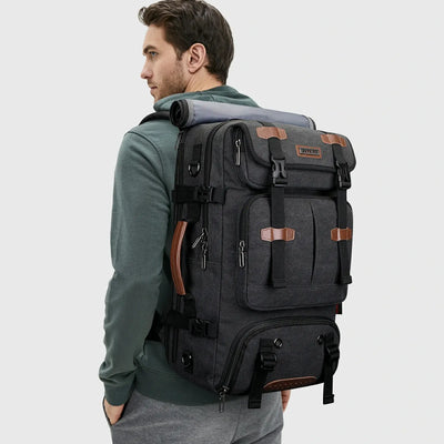 Man wearing WITZMAN black canvas travel backpack for weekend and business travel