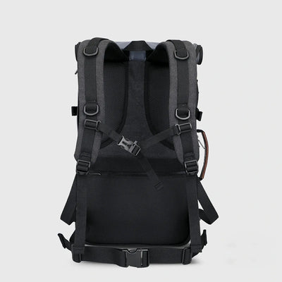 Back view of black canvas travel backpack with breathable padding, chest strap and waist belt