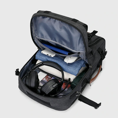 Black canvas travel backpack with spacious main compartment open for organized packing