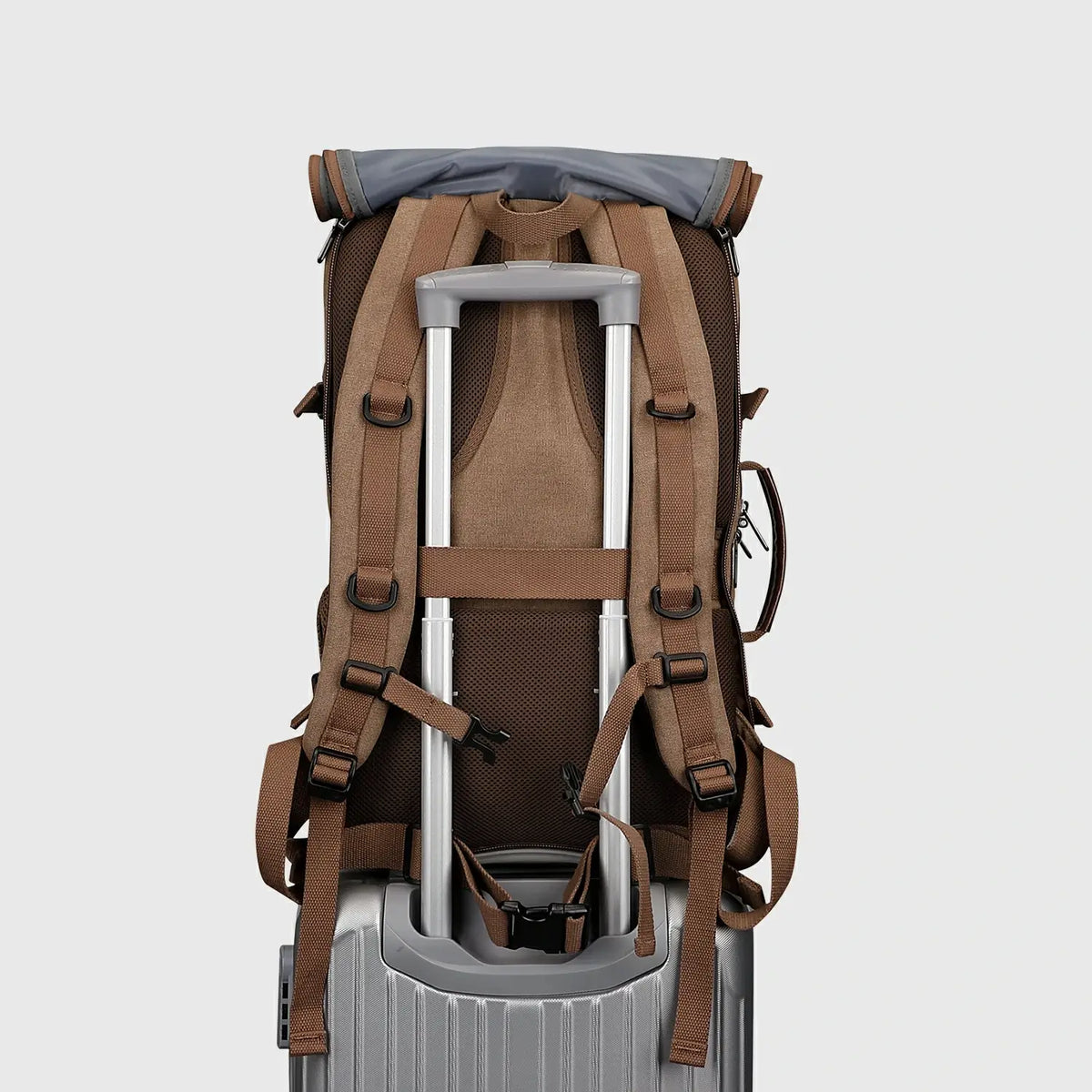 Brown 3-in-1 travel backpack with shoulder straps stored behind the roll-top back panel