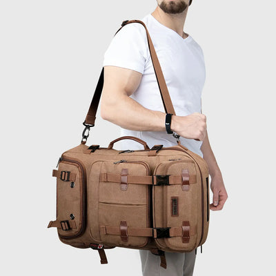 Brown convertible canvas travel backpack carried as a crossbody shoulder bag by a male traveler