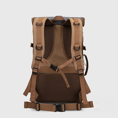 Back view of brown canvas travel backpack with breathable padding, chest strap and waist belt
