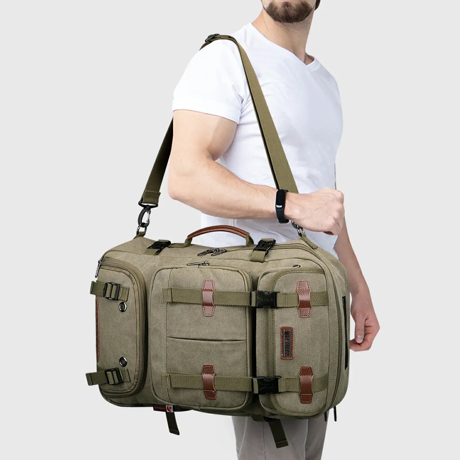 Army green convertible travel backpack carried as a crossbody shoulder bag by a male traveler