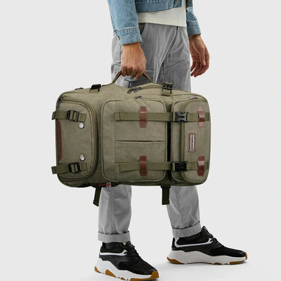 Army green 3-in-1 canvas travel backpack carried by the side handle in duffel bag mode