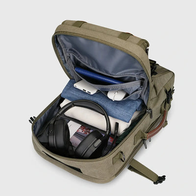 Army green canvas travel backpack with spacious main compartment open for organized packing