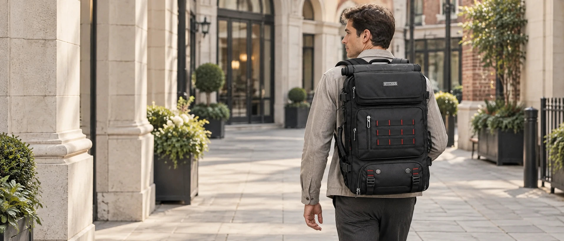 WITZMAN B682 black travel backpack worn by a tall British traveler in a dry hotel courtyard